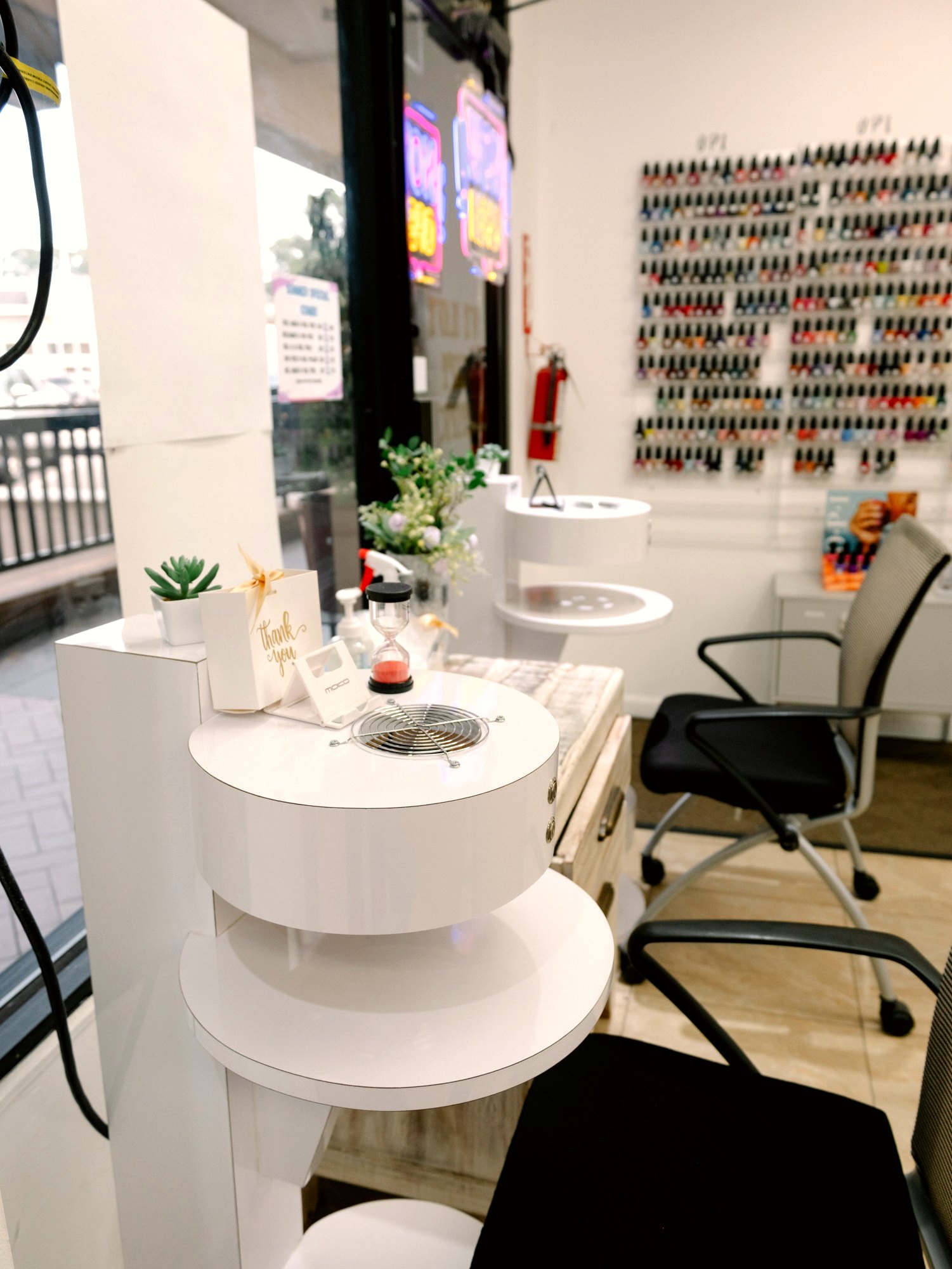Bright manicure station at Julie's Nails with a wall of polish colors behind it