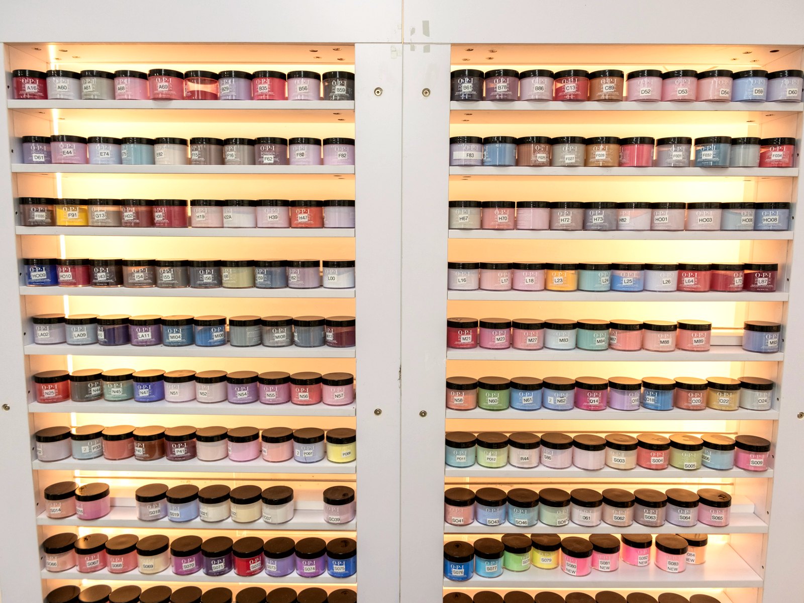 Lit shelves of OPI dipping powder colors
