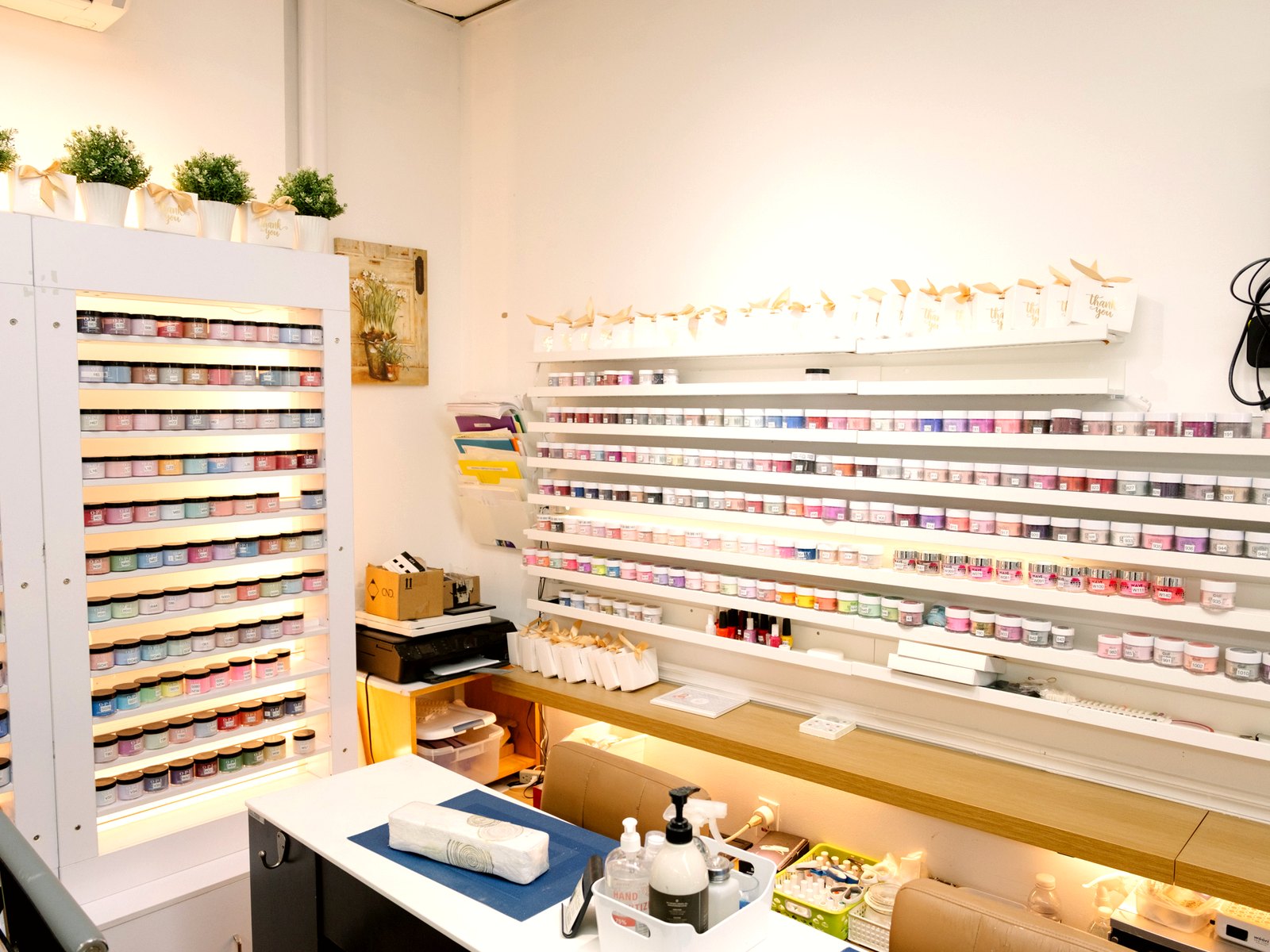 Manicure room with lit powder and polish shelves